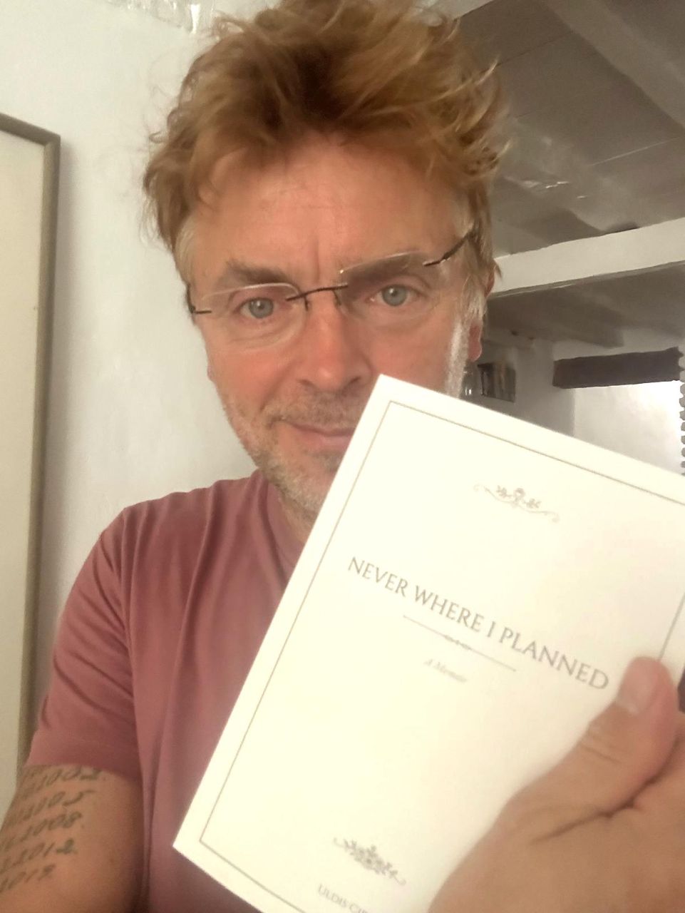 An author holding the finished book